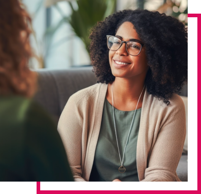 Woman with glasses speaking with medical professional