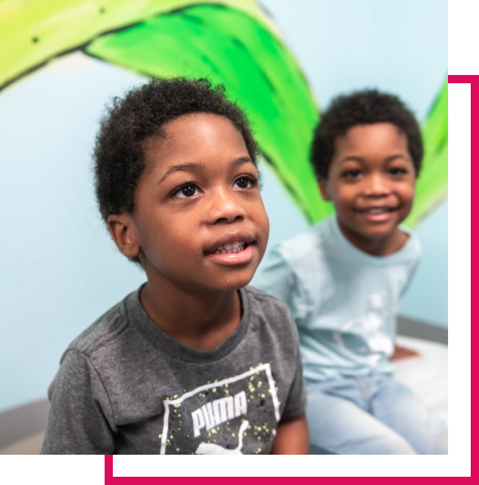 Two child patients smiling at Swope Health