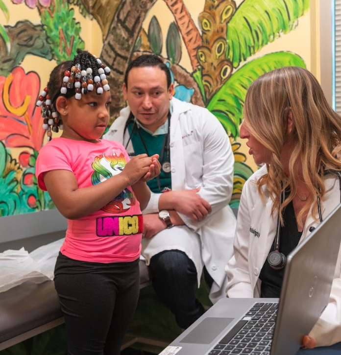 Two Swope health pediatricians speaking with child patient